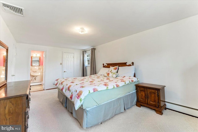 bedroom with a baseboard radiator, light carpet, and connected bathroom