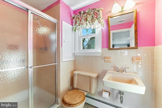 bathroom featuring sink, walk in shower, tile walls, and toilet