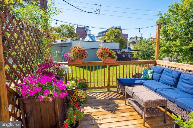 wooden deck with a lawn and an outdoor hangout area