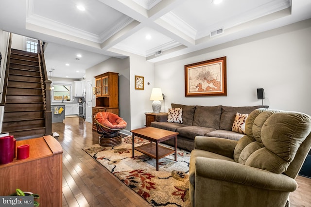 living room featuring coffered ceiling, crown molding, beam ceiling, and wood-type flooring