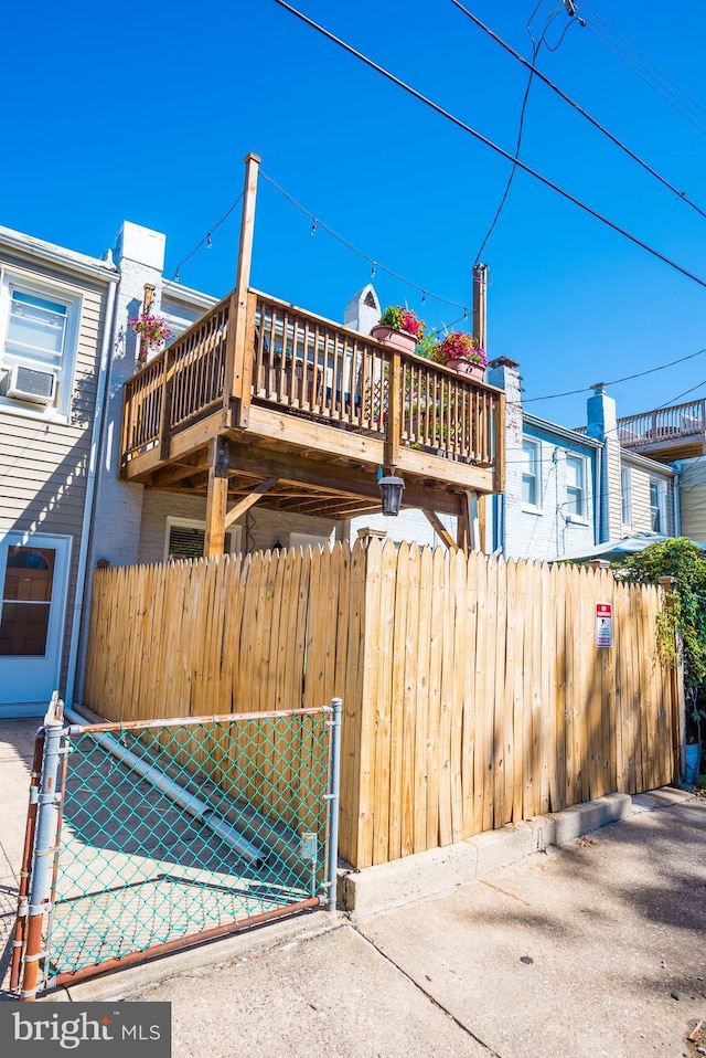 view of side of home with a deck and cooling unit