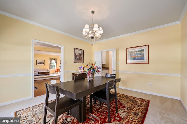 dining room with light carpet, ornamental molding, and an inviting chandelier