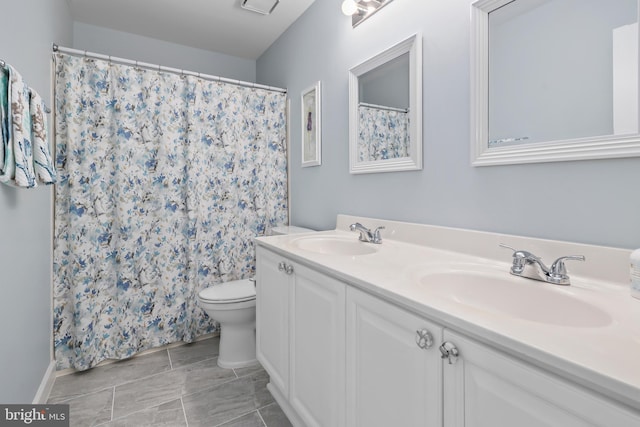 bathroom featuring toilet and vanity