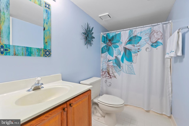 bathroom featuring vanity, toilet, and a shower with shower curtain