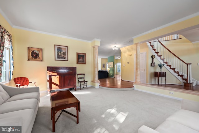 living room featuring decorative columns, carpet flooring, and crown molding