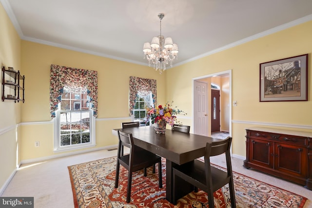 carpeted dining area featuring crown molding and a chandelier