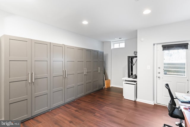 unfurnished office featuring dark wood-style floors, visible vents, recessed lighting, and baseboards