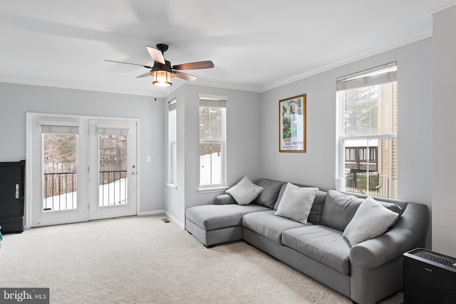 carpeted living area featuring a wealth of natural light, baseboards, and ornamental molding