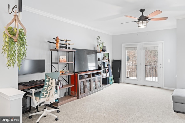 carpeted home office with crown molding and a ceiling fan