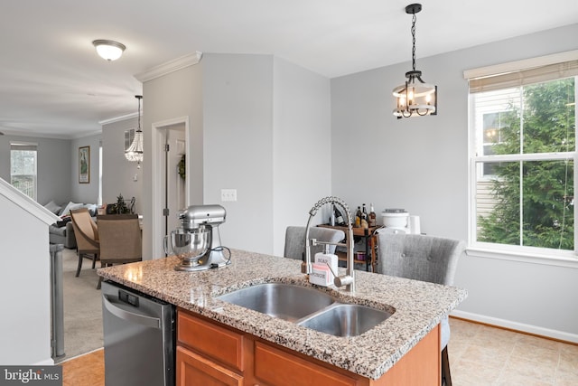 kitchen featuring brown cabinetry, decorative light fixtures, dishwasher, and a sink