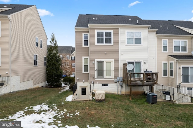 rear view of property with a lawn and central AC