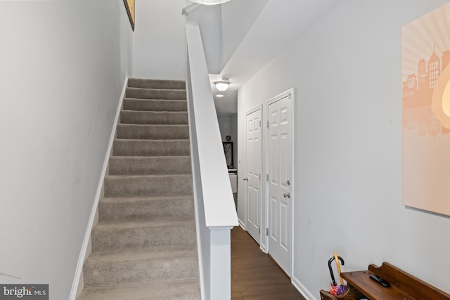 stairway featuring baseboards and wood finished floors