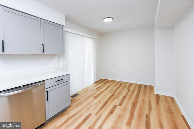 kitchen featuring light wood-type flooring, dishwasher, and gray cabinetry