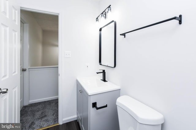 bathroom featuring toilet and vanity