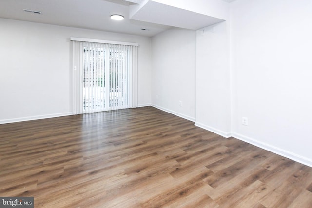 unfurnished room featuring dark hardwood / wood-style flooring