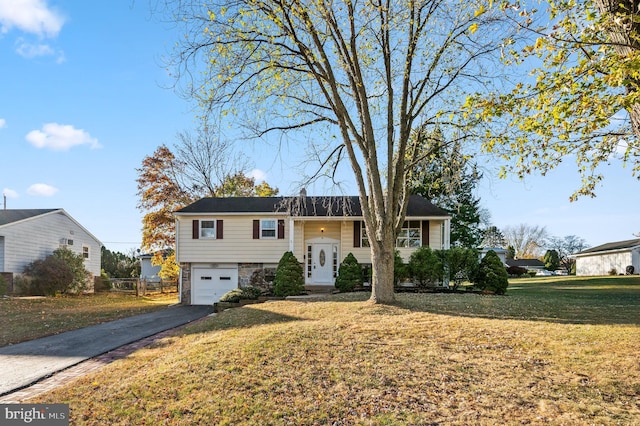 bi-level home featuring a garage and a front yard