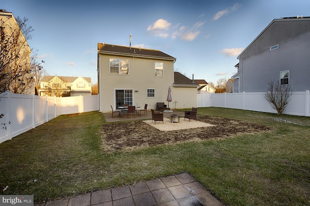 rear view of house with a patio area and a lawn