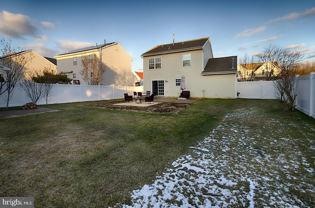 back of house featuring a patio and a lawn