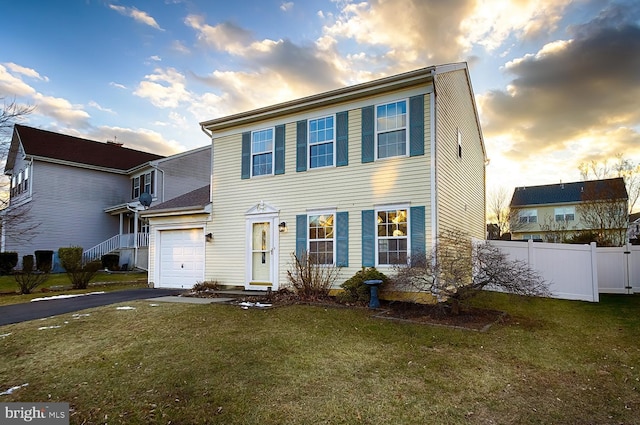 view of front of home with a lawn and a garage