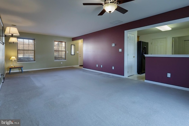 spare room featuring ceiling fan and light carpet