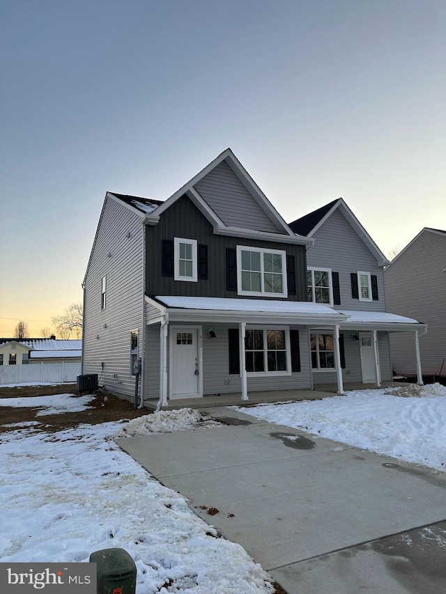 view of front of home featuring covered porch and cooling unit