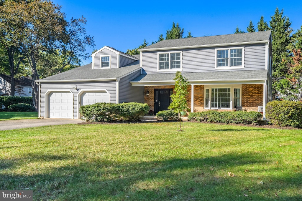 front facade featuring a front lawn and a garage