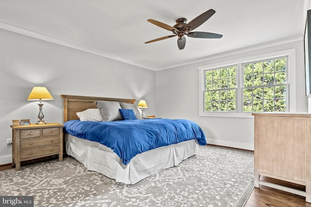 bedroom with ceiling fan, wood-type flooring, and ornamental molding