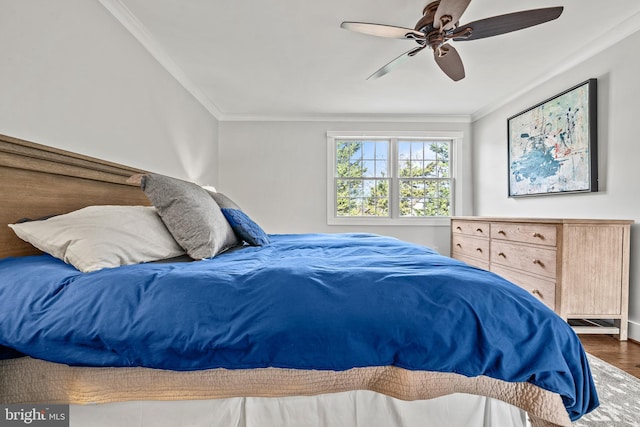 bedroom with dark wood-type flooring, ceiling fan, and crown molding