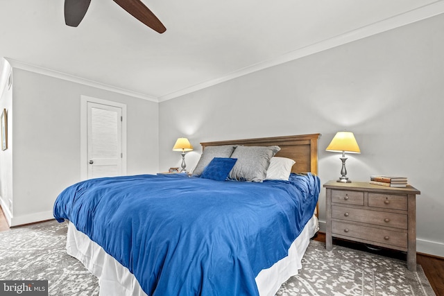 bedroom featuring ceiling fan, ornamental molding, a closet, and hardwood / wood-style flooring