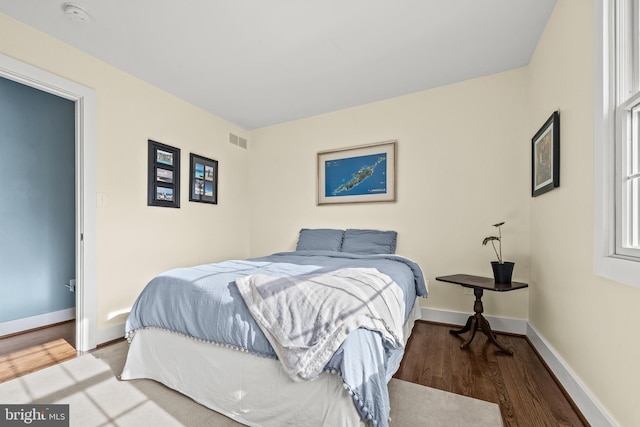 bedroom with hardwood / wood-style flooring