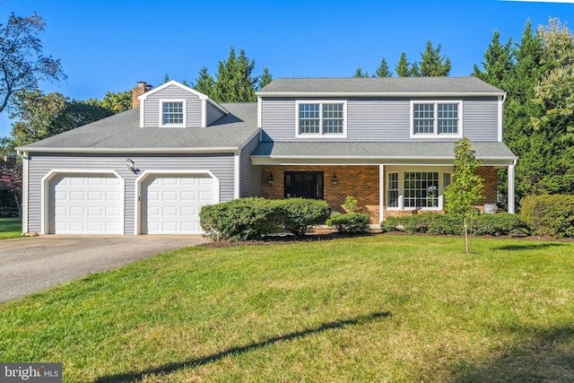 view of property featuring a front lawn and a garage