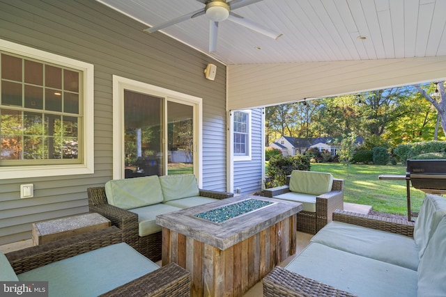 view of patio featuring ceiling fan and an outdoor living space with a fire pit