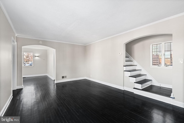 unfurnished room featuring dark hardwood / wood-style flooring, ornamental molding, and a healthy amount of sunlight