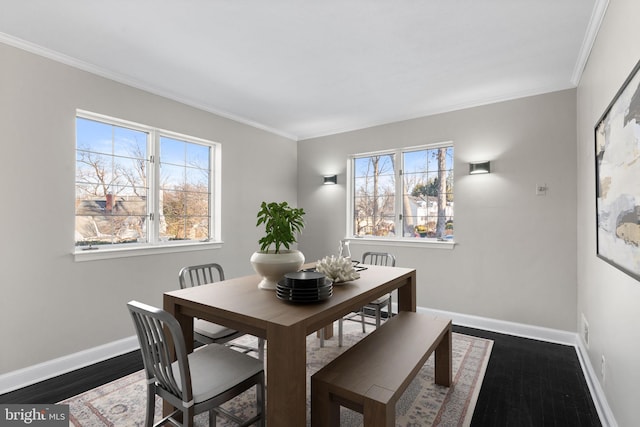 dining room featuring ornamental molding, a healthy amount of sunlight, and dark hardwood / wood-style flooring