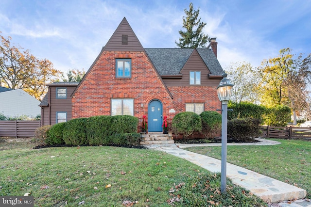 tudor house featuring a front lawn