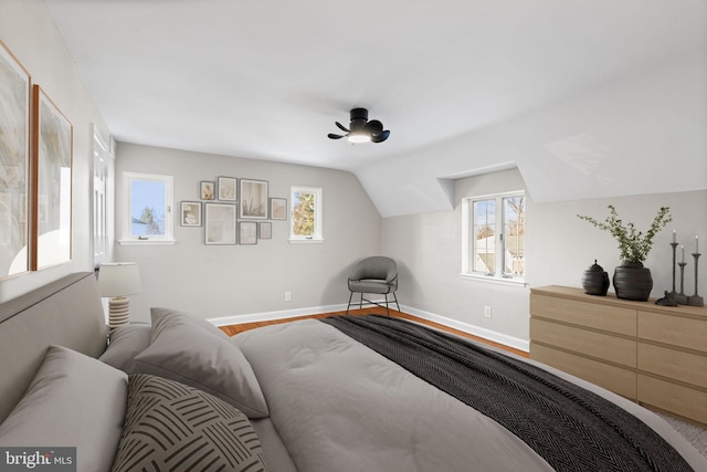 bedroom with lofted ceiling and hardwood / wood-style flooring