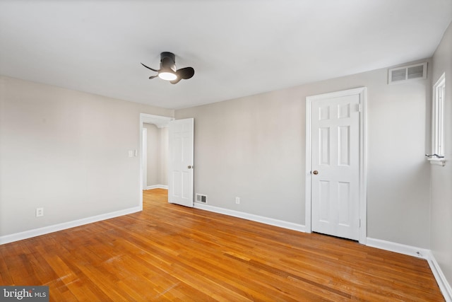 spare room with light wood-type flooring and ceiling fan