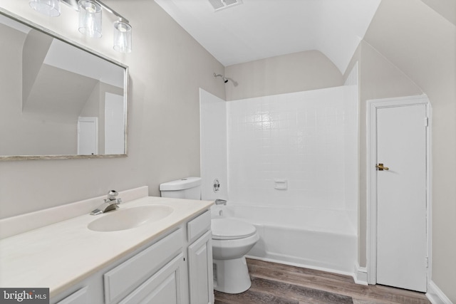 full bathroom featuring toilet, shower / bath combination, hardwood / wood-style flooring, and vanity