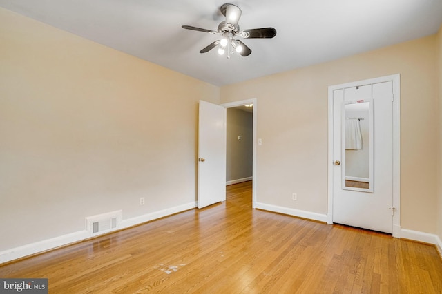 spare room with ceiling fan and light hardwood / wood-style floors