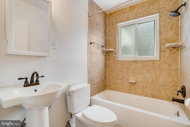 full bathroom featuring tiled shower / bath, sink, and toilet