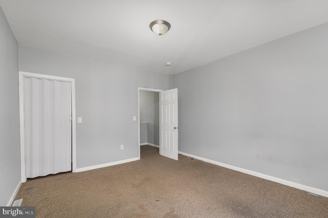 unfurnished bedroom with a closet and carpet flooring