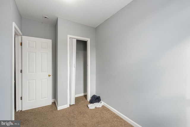 unfurnished bedroom featuring dark colored carpet