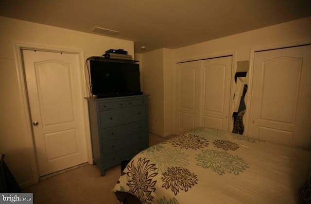 bedroom featuring light colored carpet