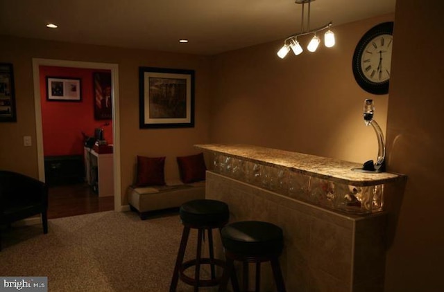 bar featuring carpet and pendant lighting