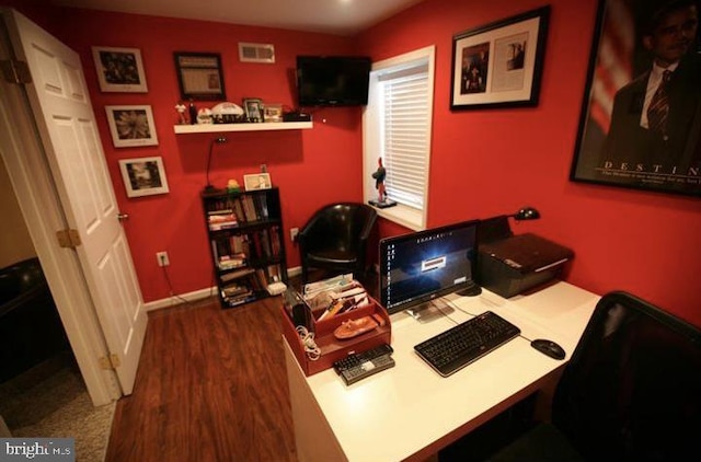 home office with dark hardwood / wood-style flooring