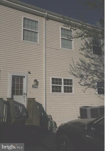 rear view of property featuring central AC