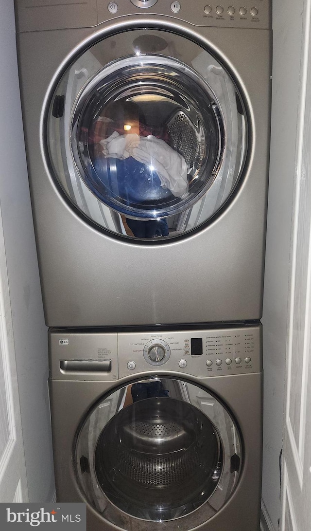 laundry room featuring stacked washer and dryer