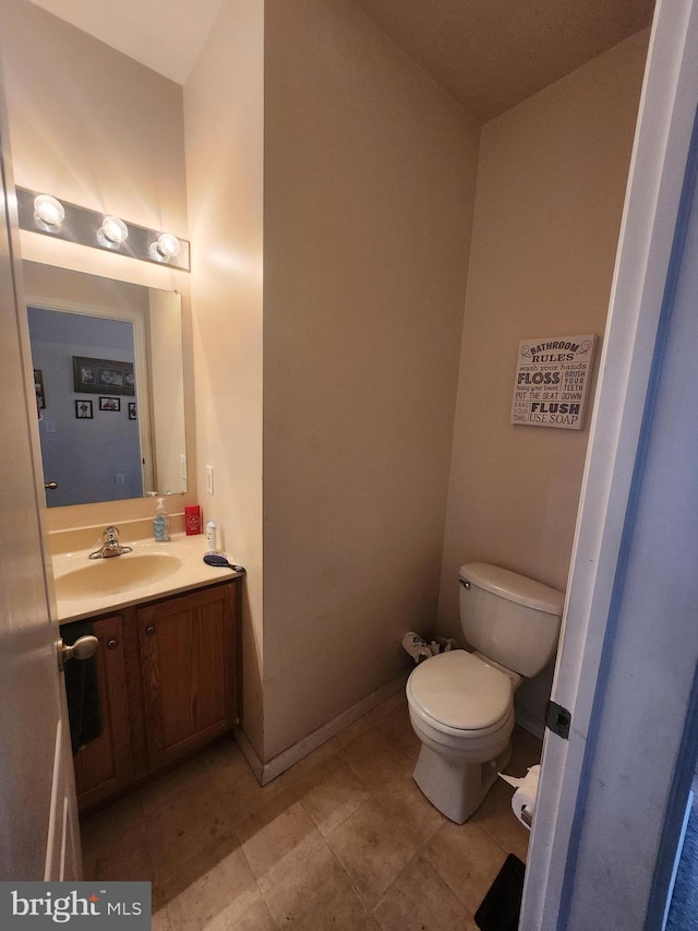 bathroom with toilet and vanity