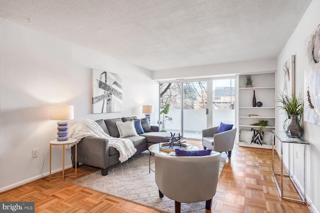 living room featuring a textured ceiling and light parquet flooring