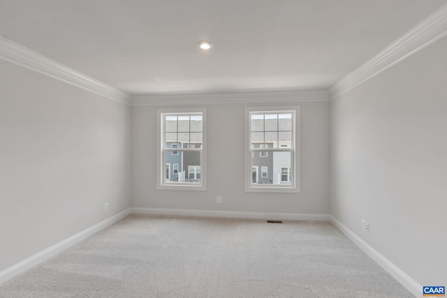 carpeted spare room with crown molding